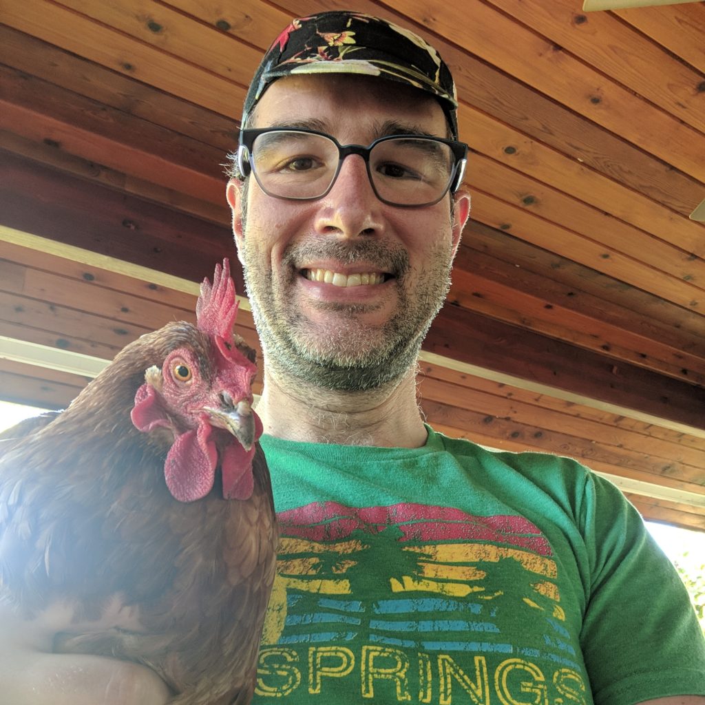 Damien Dabrowski with a chicken.